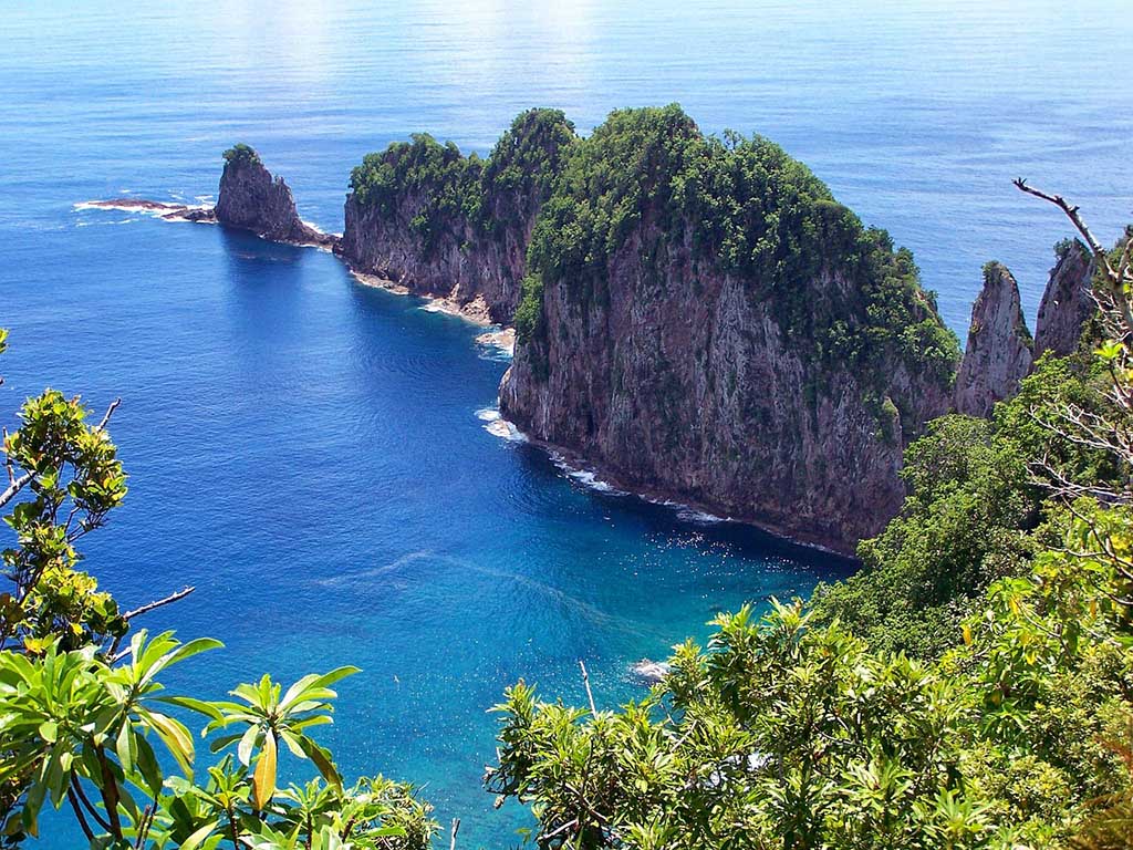 List of National Parks by State: A Complete List of All 400+ US National Parks 64 A set of rocks with plants on top stems from an island in the ocean
