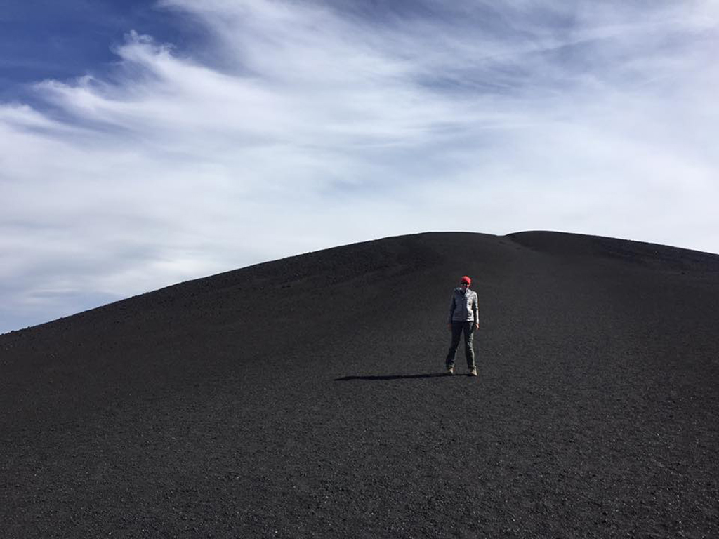 List of National Parks by State: A Complete List of All 400+ US National Parks 25 A woman standing on a black dormant volano