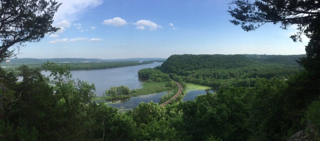 List of National Parks by State: A Complete List of All 400+ US National Parks 28 A bright across the water viewed from a green hill above
