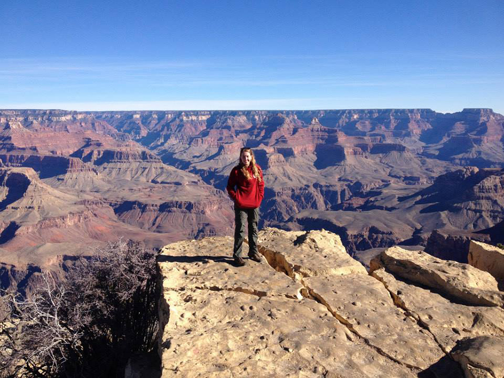 List of National Parks by State: A Complete List of All 400+ US National Parks 16 A woman in red standing on the edge of the Grand Canyon