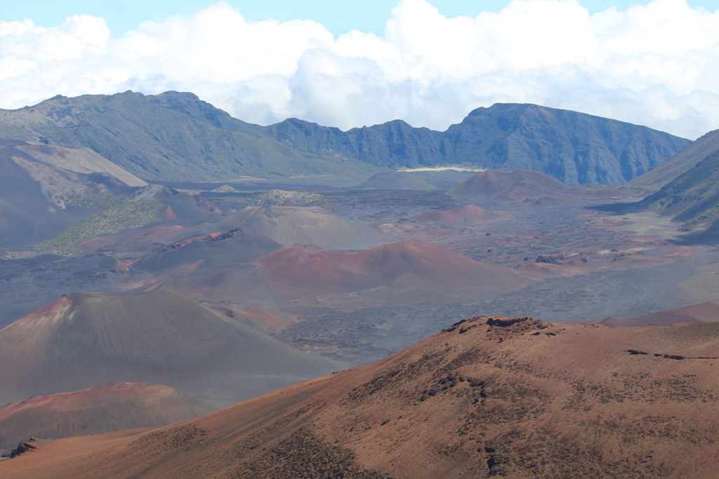 List of National Parks by State: A Complete List of All 400+ US National Parks 24 Red and brown sand mix in a caldera between mountains
