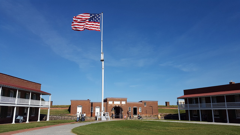 List of National Parks by State: A Complete List of All 400+ US National Parks 33 A large American flag waves above a brick fort