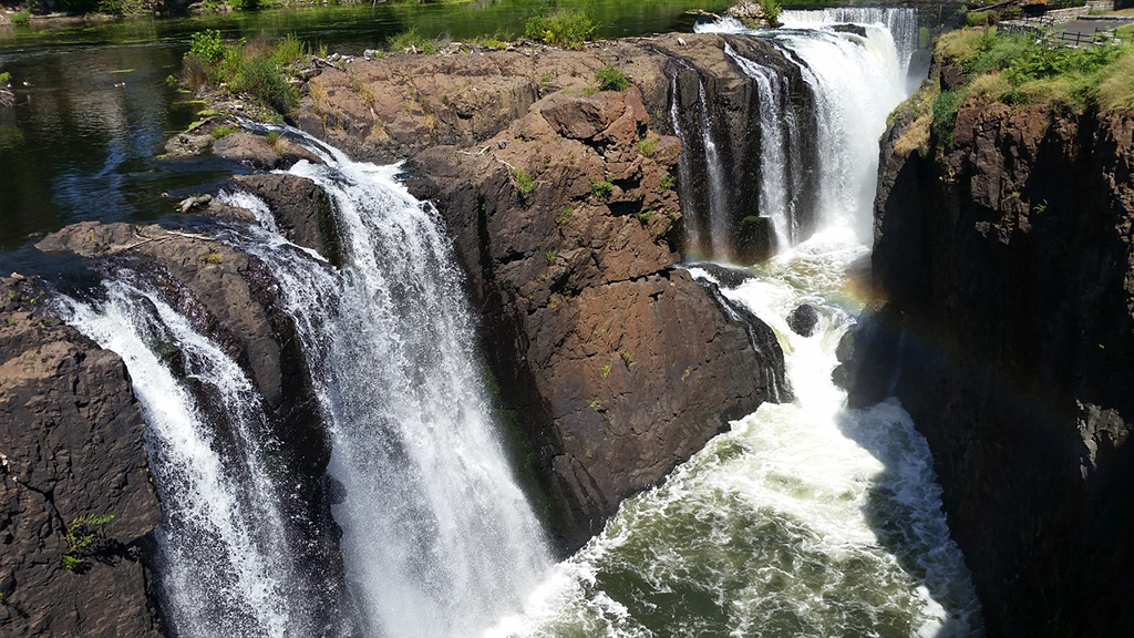 List of National Parks by State: A Complete List of All 400+ US National Parks 43 A waterfall with multiple streams cascades down a brown rockface below a waterfall