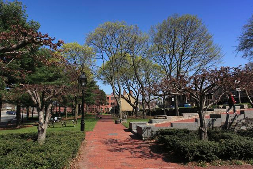 List of National Parks by State: A Complete List of All 400+ US National Parks 52 A brick walkway through a park with green grass, trees, and brick buildings