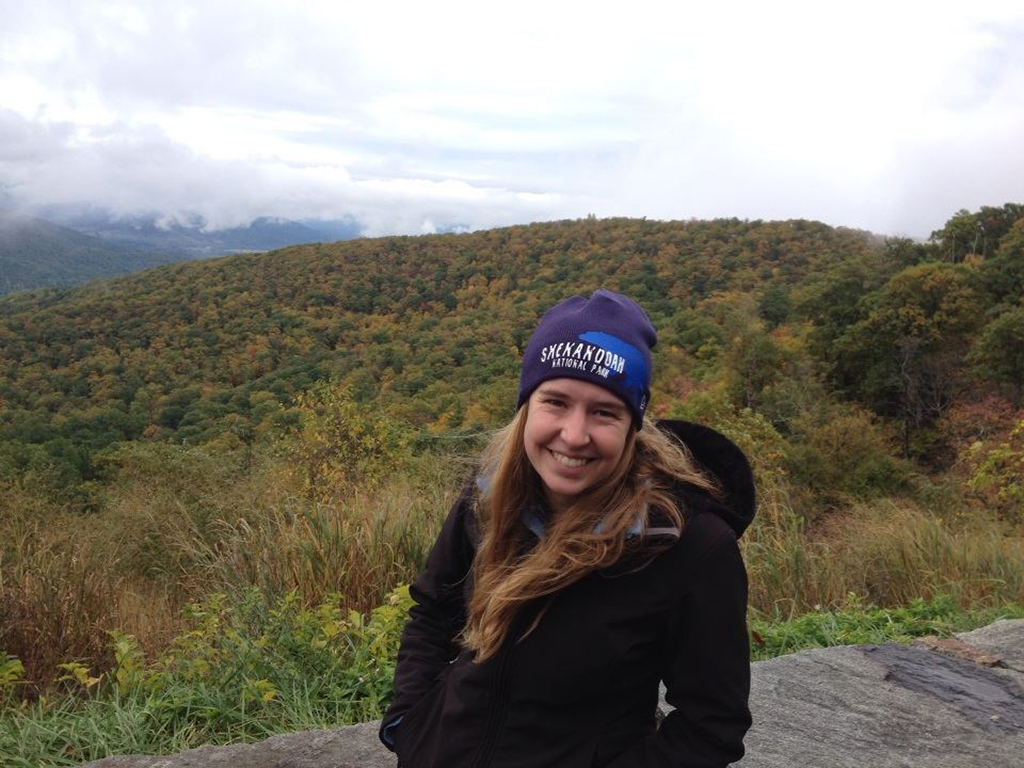 List of National Parks by State: A Complete List of All 400+ US National Parks 59 A woman smiling in front of a forest during autumn