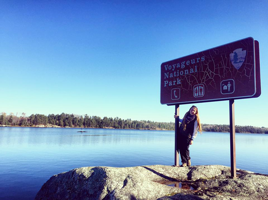 List of National Parks by State: A Complete List of All 400+ US National Parks 36 A woman poses with a sign welcoming visitors to Voyageurs National Park