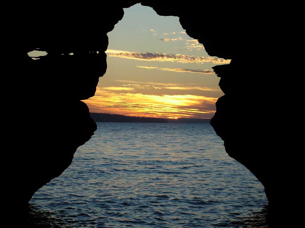 List of National Parks by State: A Complete List of All 400+ US National Parks 62 A glimpse of the sun setting over the ocean from inside a cave