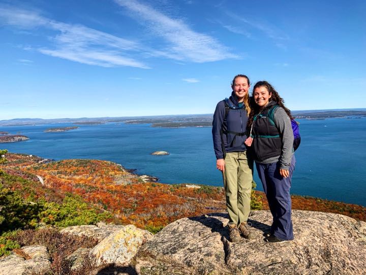 How to Hike the Heart-Stopping Precipice Trail in Acadia National Park 18 Two women stand on top of a mountain smiling