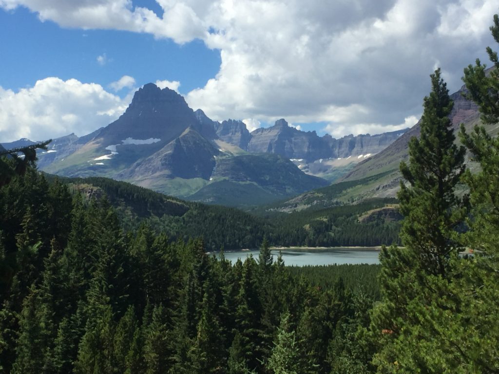 Cracker Lake Trail: One of the Most Beautiful Hikes in Glacier National Park 4 Tall mountains reflected in a small turquoise pond below