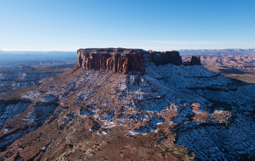 Visiting Canyonlands National Park: The Expert Travel Guide 8 A red plateau with snow at the base