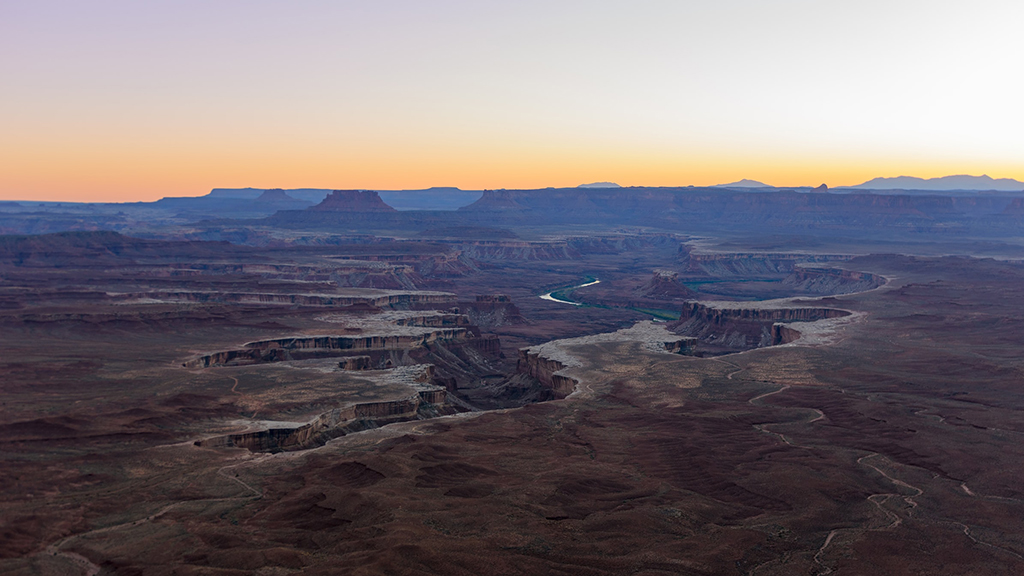 Visiting Canyonlands National Park: The Expert Travel Guide 1 The Green River Overlook at Canyonlands National Park at sunset. This is one of the best places to go when visiting Canyonlands National Park.