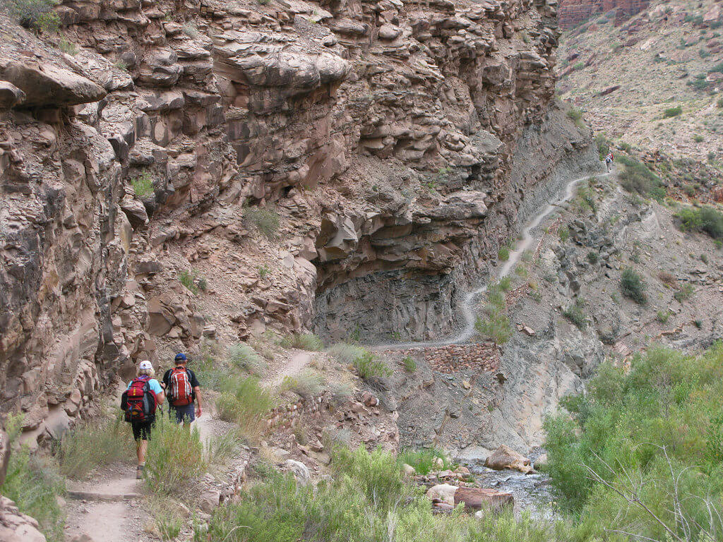 Visiting Grand Canyon National Park: The Expert Travel Guide 14 Two visitors hiking the North Kaibab Trail while visiting Grand Canyon National Park