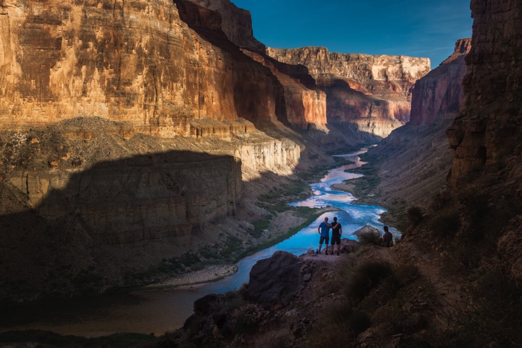 Visiting Grand Canyon National Park: The Expert Travel Guide 9 Two hikers standing above the Colorado River when visiting Grand Canyon National Park
