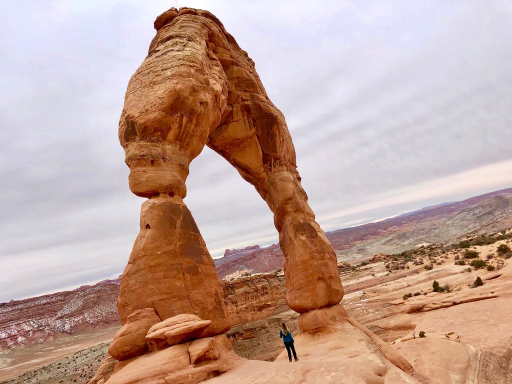 A List of All 63 National Parks in the U.S. Ranked by Their Popularity 42 A woman stands under Delicate Arch in Arches, one of the US national parks