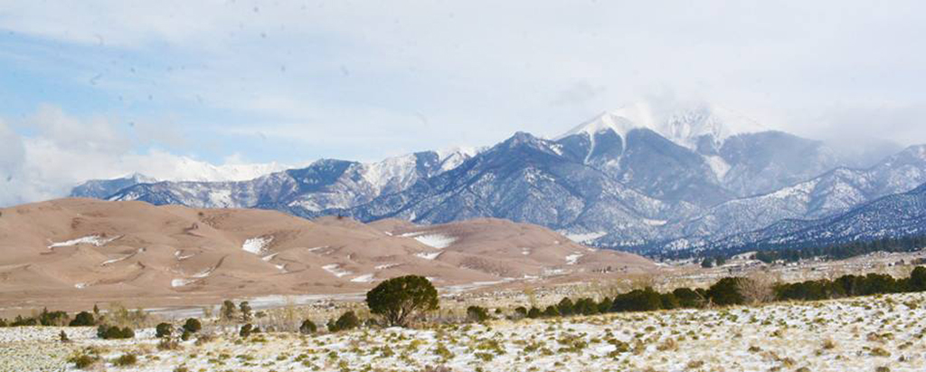 A List of All 63 National Parks in the U.S. Ranked by Their Popularity 60 Clouds roll over mountains and sand dunes in Great Sand Dunes, one of the US national parks