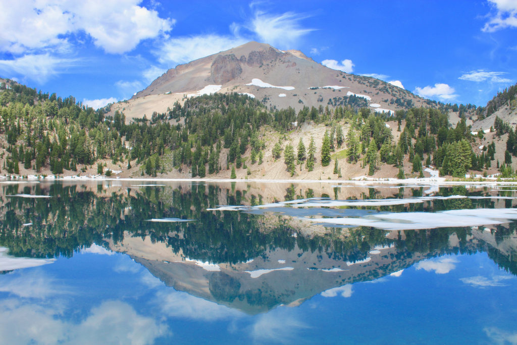 A List of All 63 National Parks in the U.S. Ranked by Their Popularity 64 The clouds and sky reflected in a lake in Lassen Volcanic, one of the US national parks