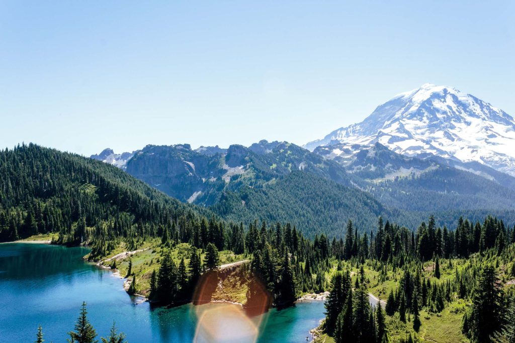A List of All 63 National Parks in the U.S. Ranked by Their Popularity 39 Over a spruce forest and alpine lake we see Mount Rainier, one of the US national parks