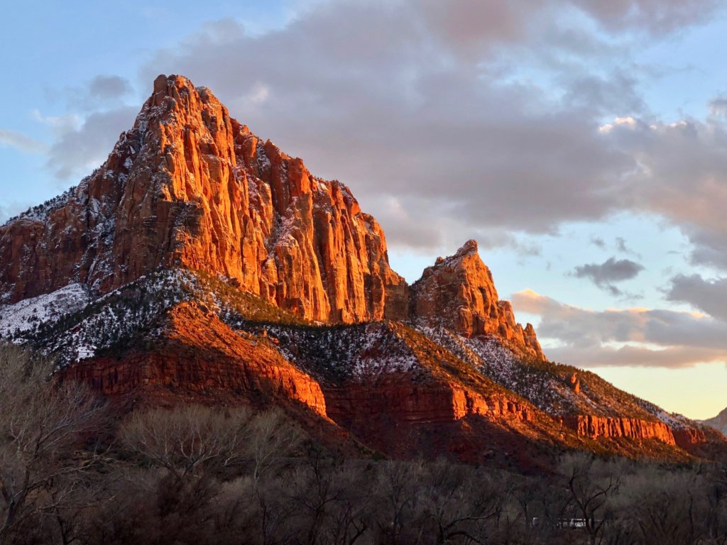 A List of All 63 National Parks in the U.S. Ranked by Their Popularity 22 The sun set casts an orange glow on the Watchman in Zion, one of the US national parks