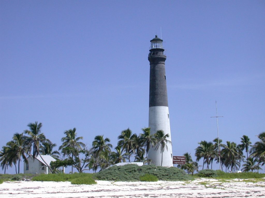 Camping at Dry Tortugas National Park: Everything You Need to Know 15 A lighthouse, white and brown, on Loggerhead Key, seen while camping at Dry Tortugas National Park