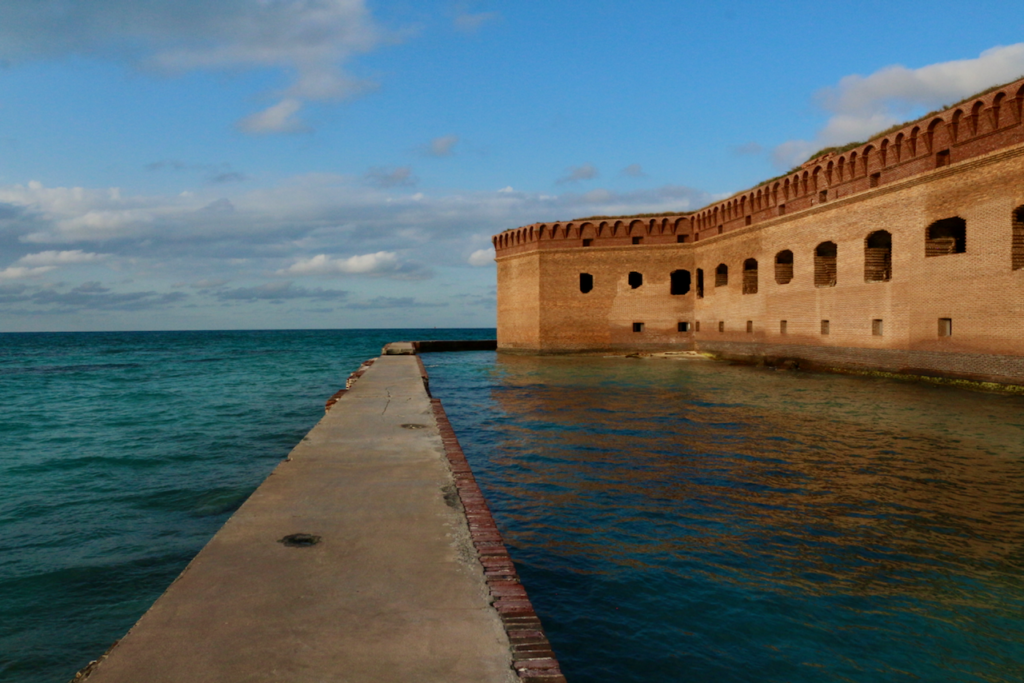 Florida Road Trip: 12-Day Florida Itinerary from Orlando to the National Parks 10 An old brick fort, its moat, and moat wall in the ocean. Seen on a Florida road trip.
