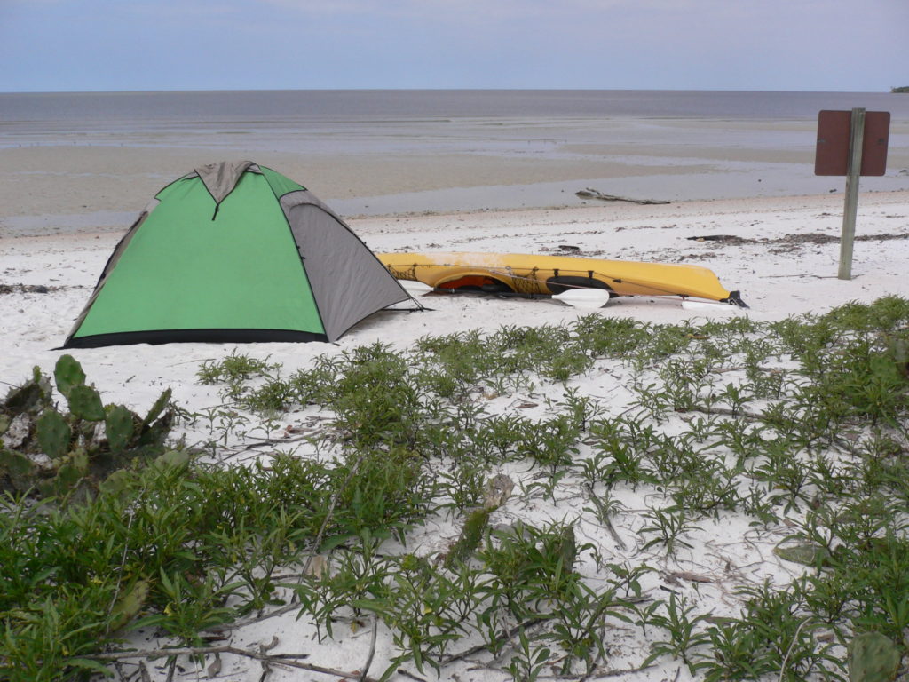 Visiting Everglades National Park: The Expert Guide 13 A tent and kayak on the beach. Photo taken while visiting Everglades National Park.