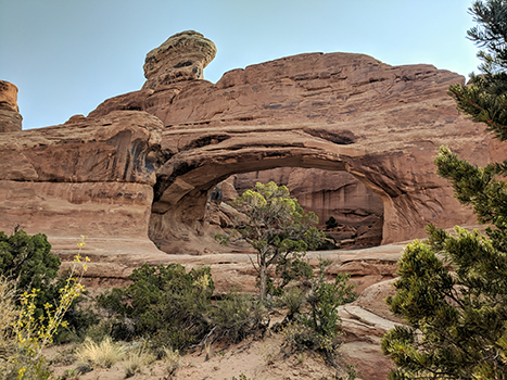 10 Best Hikes in Arches National Park That Lead to the Greatest Natural Arches in Utah 14 A round arch below a tower-shaped rock pinnacle. Tower Arch is one of the best hikes in Arches National Park.