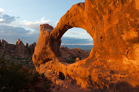 10 Best Hikes in Arches National Park That Lead to the Greatest Natural Arches in Utah 13 A large circular arch frames snow-capped mountains in the distance. Double O Arch is one of the best hikes in Arches National Park