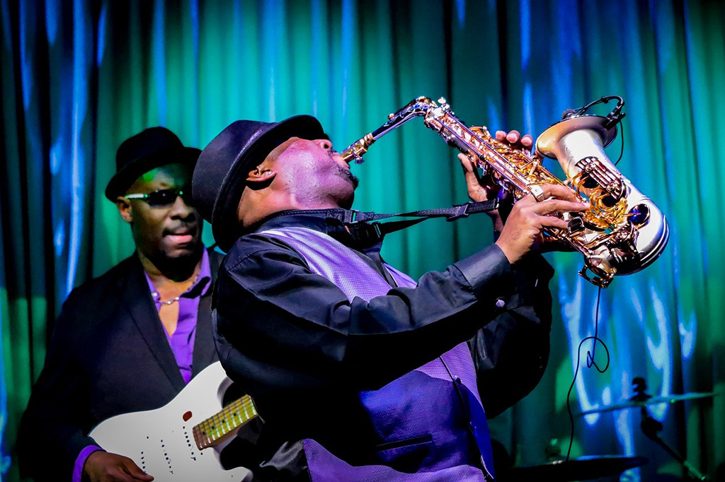 4 Lovely National Parks in Louisiana 7 A jazz musician plays saxophone with a bass guitarist behind him. New Orleans Jazz National Historical Park, one of the national parks in Louisiana, celebrates the thriving Jazz music scene through New Orleans' history.