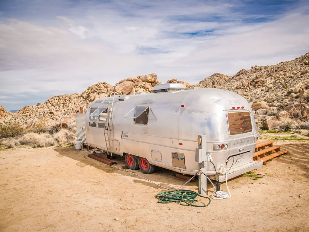 The 17 Most Amazing Things to Do in Joshua Tree National Park That Stole My Heart 29 A silver Airstream parked in the desert. This is one of the best places to stay while checking out things to do in Joshua Tree.