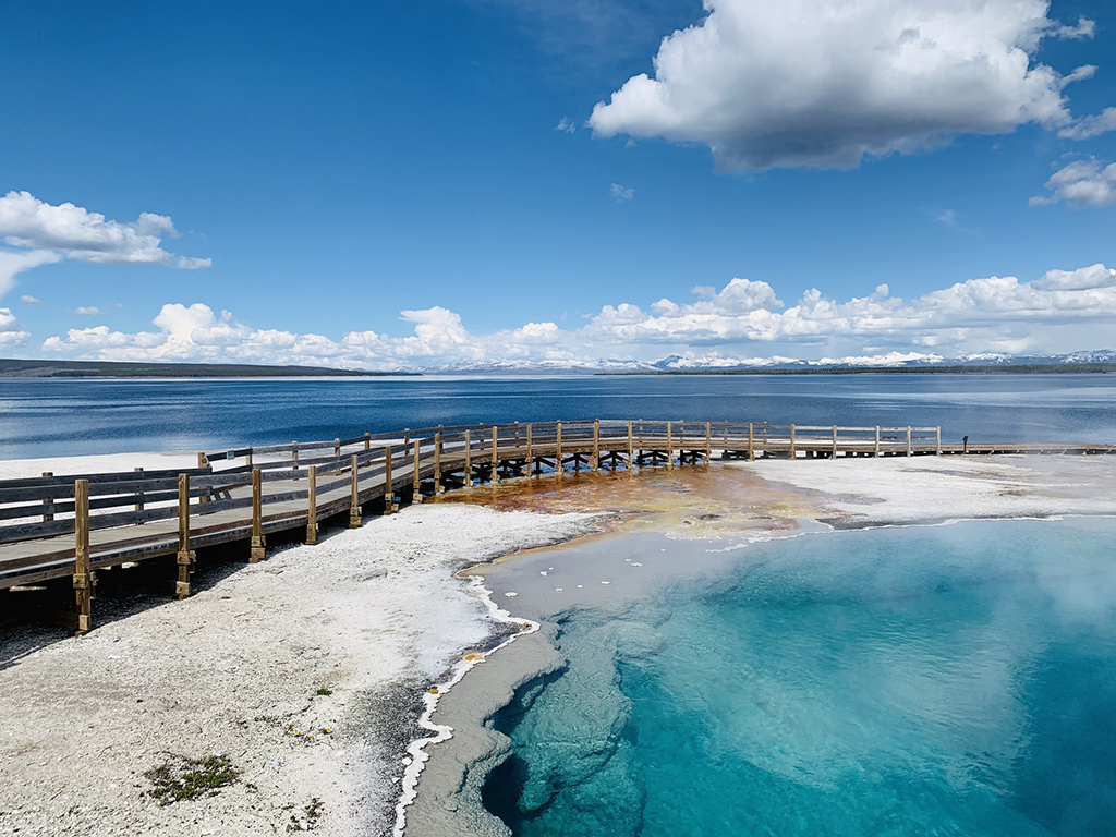 Yellowstone Itinerary: 4 Days in the World's First National Park 5 A boardwalk between a geyser basin and a large lake. West Thumb is a unique must-see for your Yellowstone itinerary.