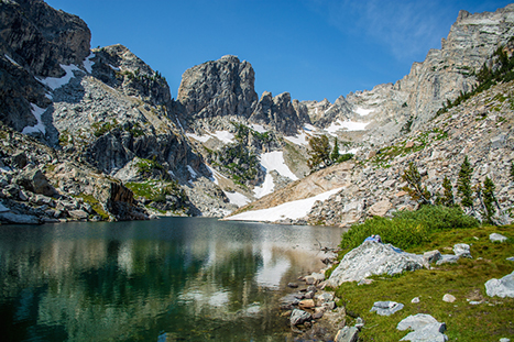 Best Hikes in Grand Teton: The 14 Best Long Day Hikes and Multi-Day Hikes in Grand Teton National Park 28 A small lake with granite mountains reflected in its waters. Hanging Canyon is one of the best hikes in Grand Teton.