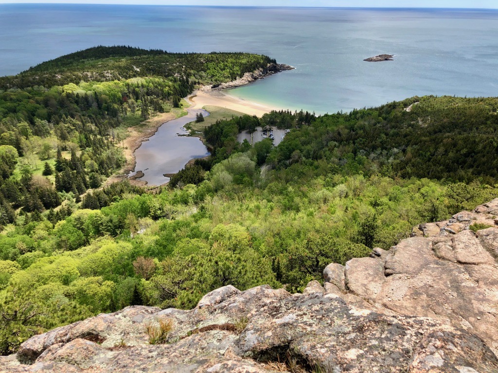15 of the Best Hikes in Acadia National Park: Exploring Mount Desert Island 54 The view of Sand Beach and Great Head from the summit of the Beehive, one of the best hikes in Acadia National Park.