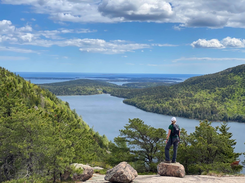 About 1 A hiker takes in the view from the North Bubble, one of the best hikes in Acadia National Park