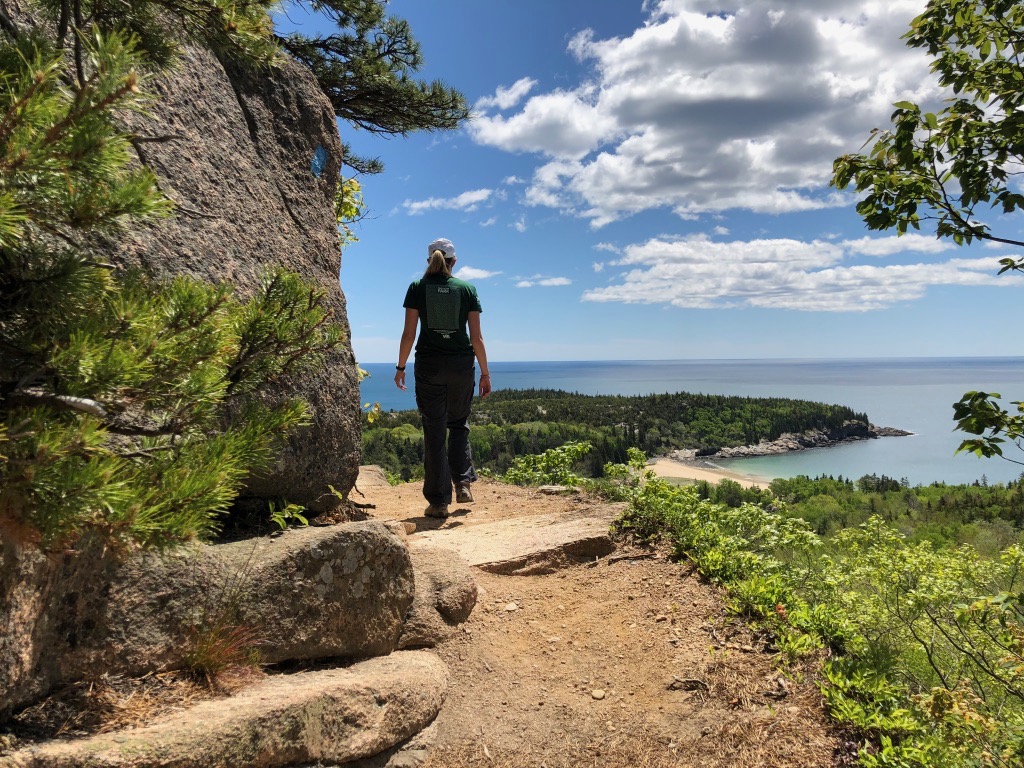 15 of the Best Hikes in Acadia National Park: Exploring Mount Desert Island 53 A hiker walks along the Beehive, known as one of the best hikes in Acadia National Park