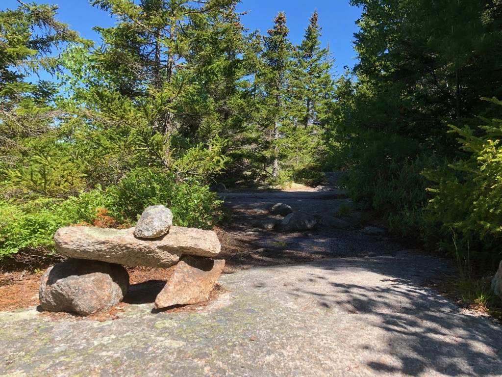 15 of the Best Hikes in Acadia National Park: Exploring Mount Desert Island 3 A cairn rests on one of the best trails in Acadia