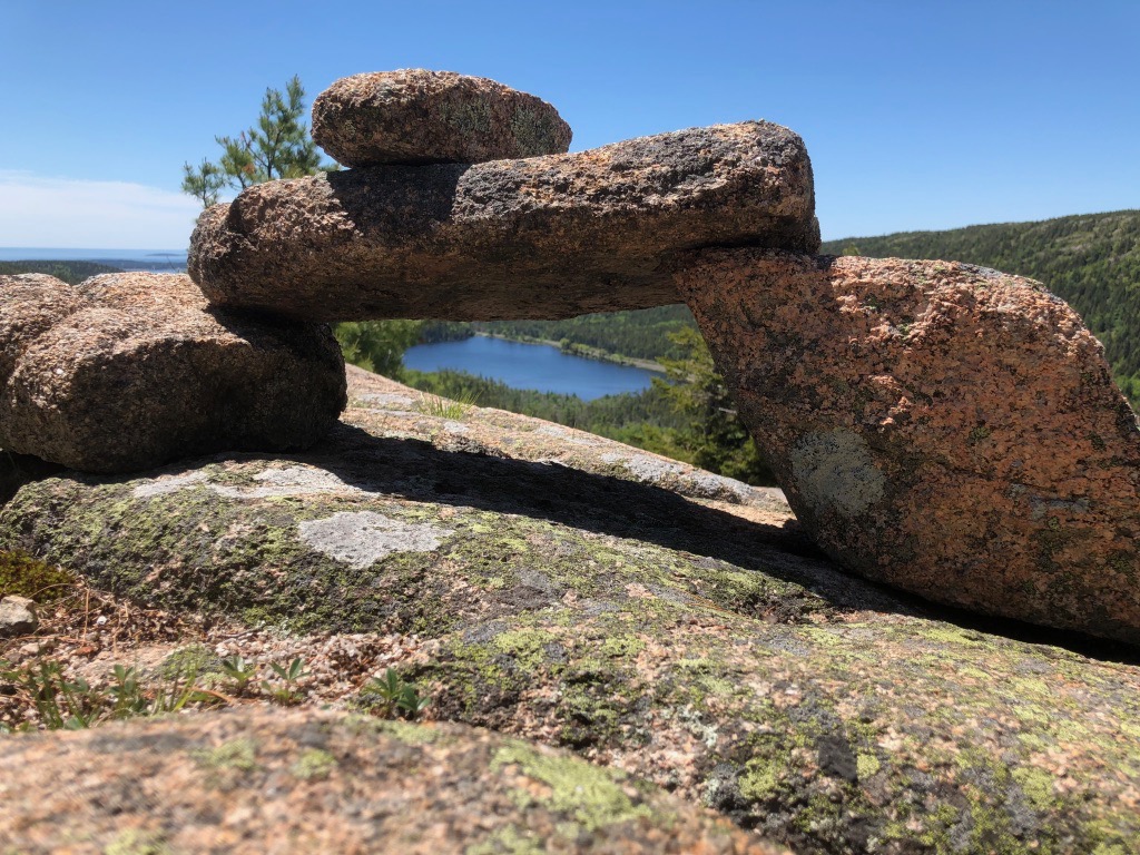 15 of the Best Hikes in Acadia National Park: Exploring Mount Desert Island 2 A cairn frames a pond on one of the best hikes in Acadia