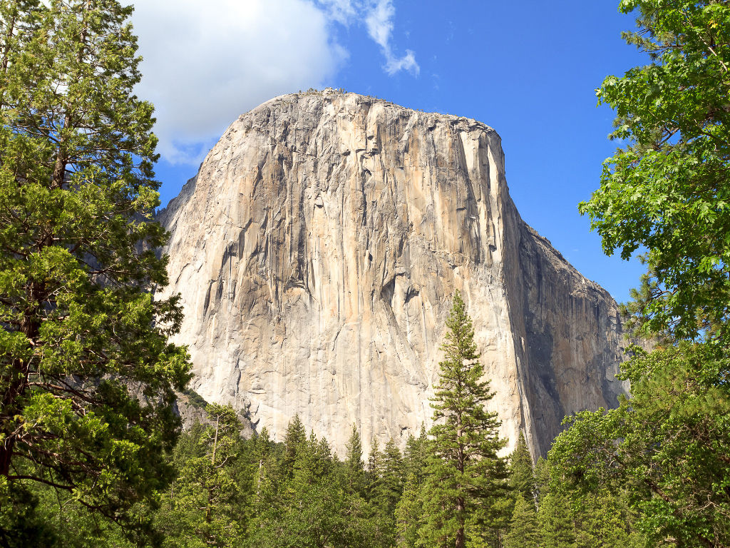 Things to Do in Yosemite Valley: The Heart of Yosemite National Park 2 A large granite rock formation surrounded by evergreen trees. It is known as El Capitan, and it's one of the must sees in Yosemite National Park.