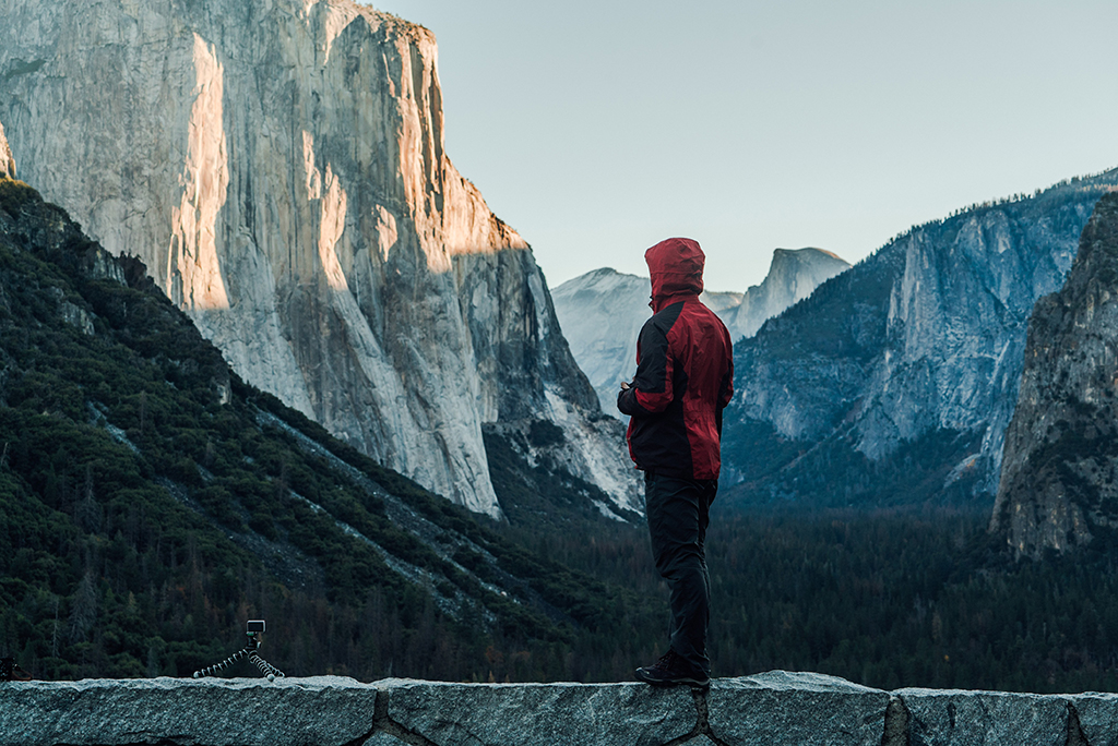 Things to Do in Yosemite Valley: The Heart of Yosemite National Park 3 A hiker with a red jacket stands near a view point at Tunnel View, one of the best things to see in Yosemite