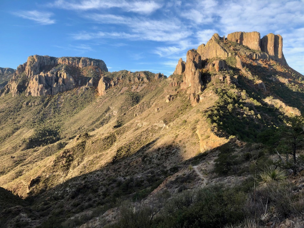 How to Spend 3 Days in Big Bend National Park: Itinerary 28 A trail winds through a valley below rocky cliffs and mountains in Big Bend National Park. Lost Mine is the perfect stop while spending 3 days in Big Bend.