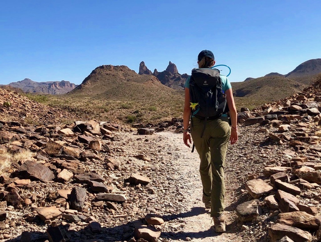 How to Spend 3 Days in Big Bend National Park: Itinerary 21 A female hiker walks toward rocks shaped like the ears of a mule while spending 3 days in Big Bend National Park