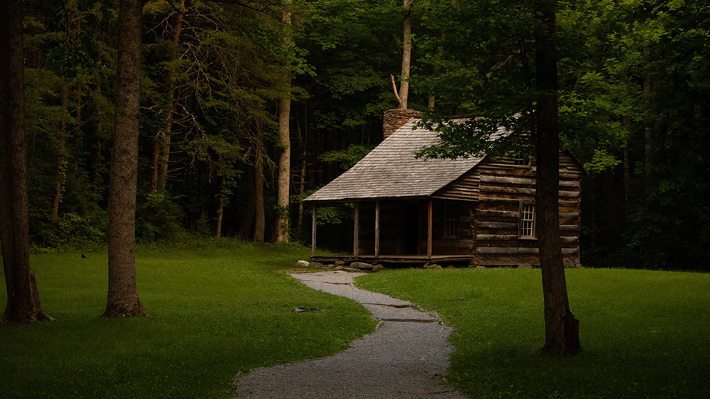 Camping in Great Smoky Mountains National Park: The Ultimate Guide to All 9 Campgrounds 9 A sidewalk leads to a historic building in Cades Cove in Great Smoky Mountains National Park