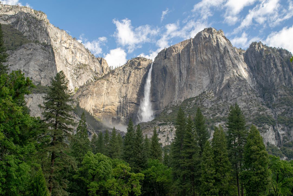 8 of the Best Hikes in Yosemite National Park for Breathtaking Views 31 A thin, tall steam of water falls from a granite monolith. Yosemite Falls is one of the most popular destinations and best hikes in Yosemite National Park.