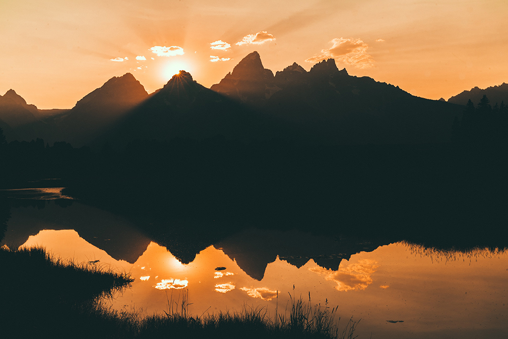 List of US National Parks in Alphabetical Order (All 400+!) 2 Orange sunset over the Teton range