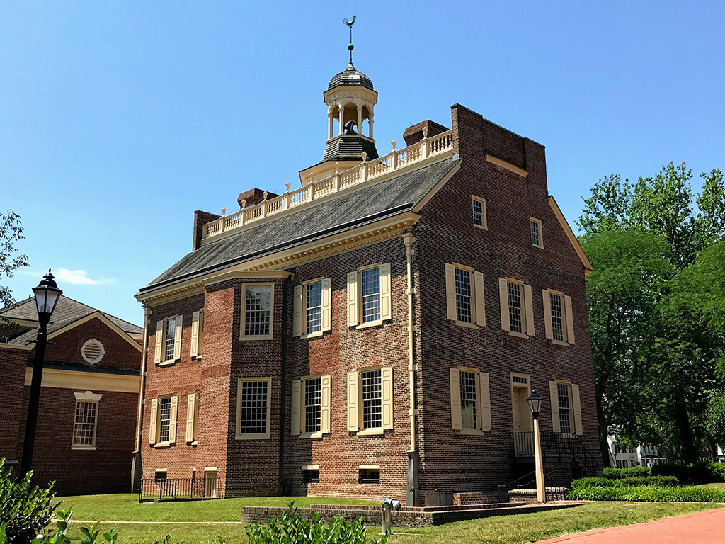List of US National Parks in Alphabetical Order (All 400+!) 23 A historic brick building sits on a square with green grass