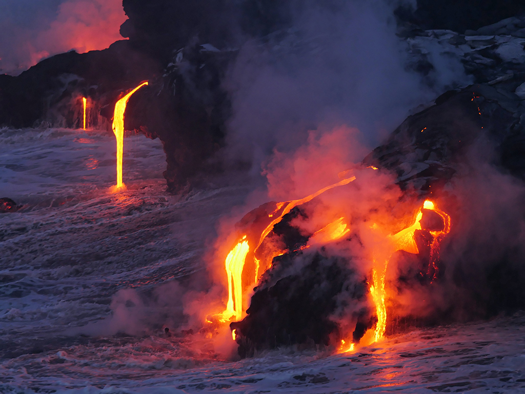 List of US National Parks in Alphabetical Order (All 400+!) 25 Red lava pours off the black land and into the ocean