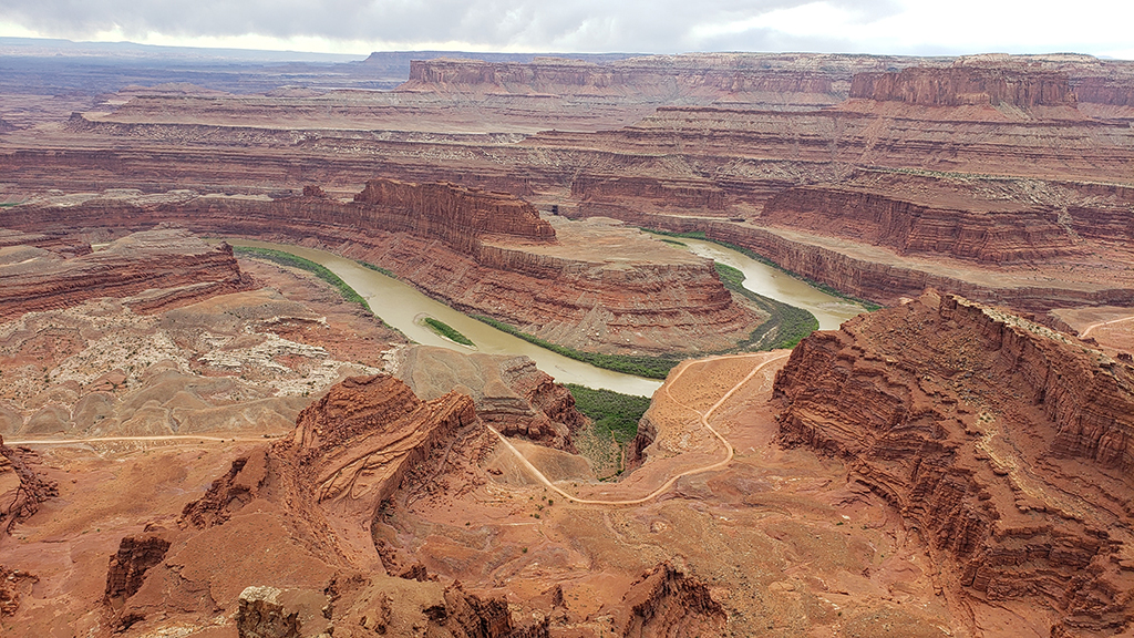 13 Unbelievable National Parks in Utah 44 A river winds through the bottom of a canyon in a U-shape in Canyonlands, one of the national parks in Utah