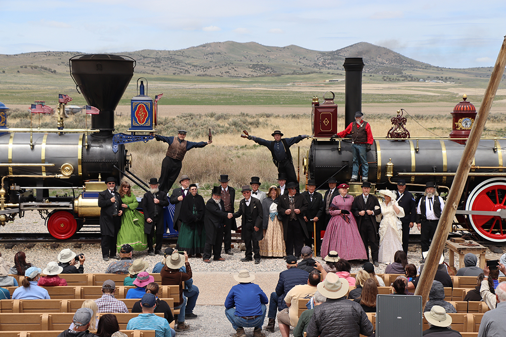 13 Unbelievable National Parks in Utah 72 The cast of a reenactment stand between two historic train engines at Golden Spike, one of the national parks in Utah