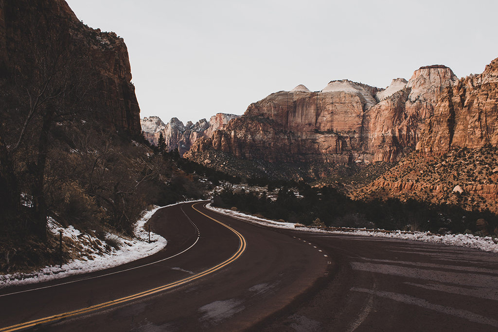 Zion Shuttle: How to Plan a Stress-Free Trip 34 A curved road with snow on the sides below rock formations