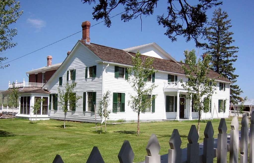 8 Marvelous National Parks in Montana 25 A large, white, historic ranch house on green grass
