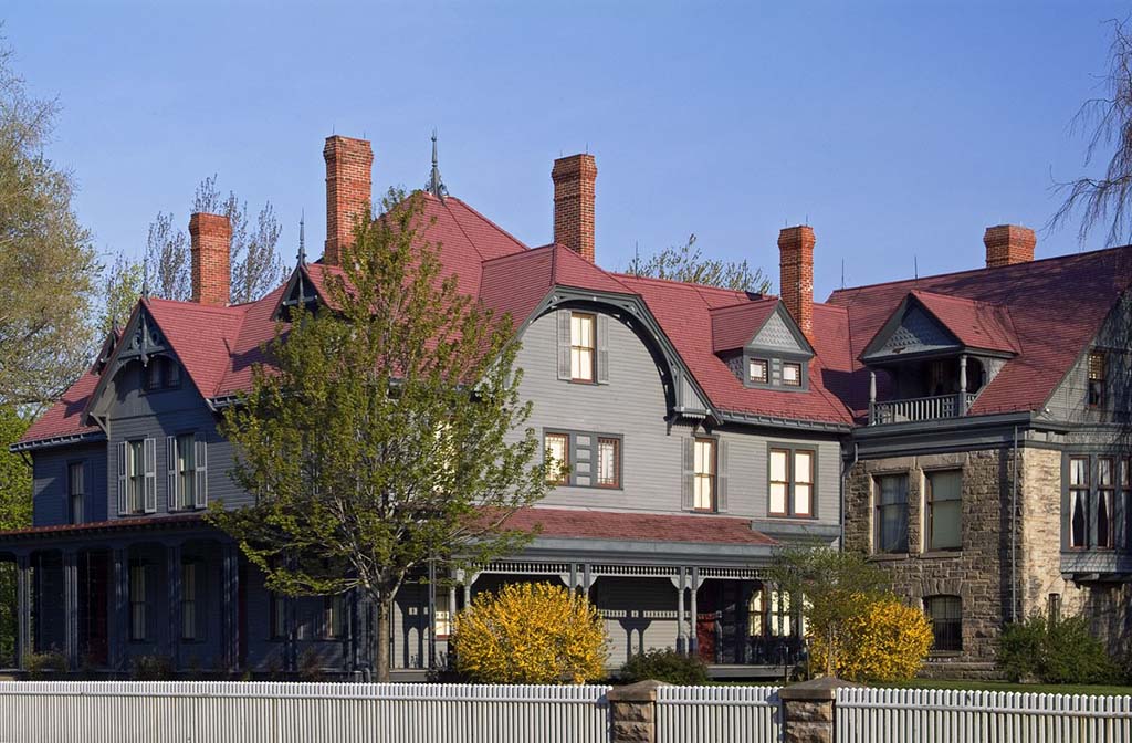 8 Outstanding National Parks in Ohio 10 A gray house with a red roof surrounded by a fence. This home was previous the childhood home of James A. Garfield, future US President.